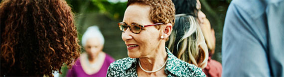 woman listening to news at a party